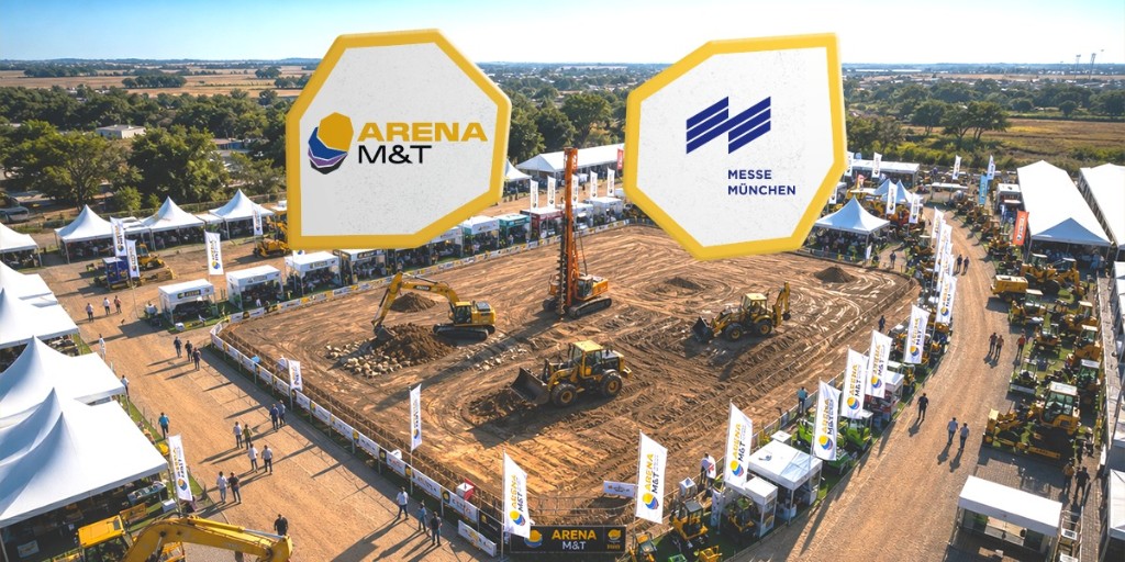 Vista aérea da Arena M&T com demonstração de equipamentos pesados em arena de terra, com logotipos Arena M&T e Messe München
